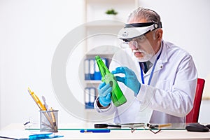 Old male expert criminologist working in the lab for evidence