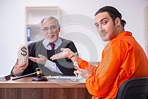 Old male judge meeting with young captive in courthouse