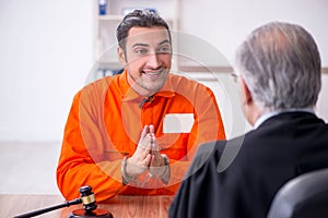 Old male judge meeting with young captive in courthouse