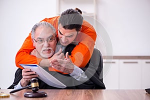 Old male judge meeting with young captive in courthouse