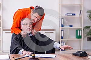 Old male judge meeting with young captive in courthouse