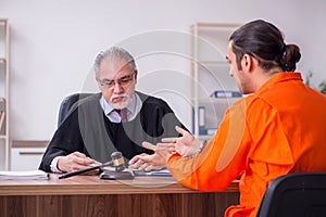 Old male judge meeting with young captive in courthouse