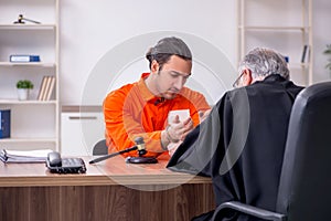 Old male judge meeting with young captive in courthouse