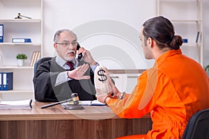 Old male judge meeting with young captive in courthouse