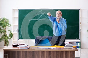 Old male math teacher in the classroom