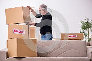 Old male professional mover doing home relocation