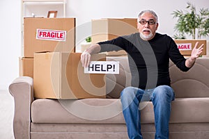 Old male professional mover doing home relocation