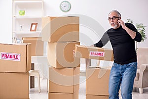 Old male professional mover doing home relocation