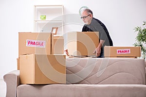 Old male professional mover doing home relocation