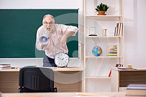 Old male teacher in time management concept