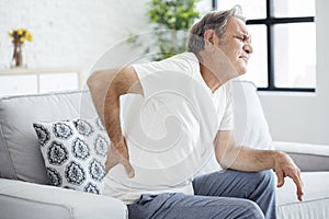 Old man with back pain photo