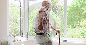 Old man, back pain or support with cane in nursing home or healthcare crisis of arthritis in living room. Elderly