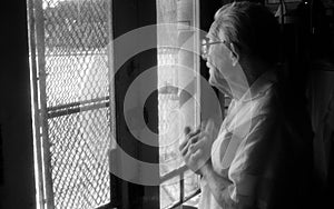 St Louis, Missouri, United States-circa 2007-Old Man Barber Staring Out Vintage Barbershop Window in City Neighborhood