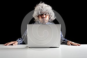 An old man boomer snorting while using computer photo