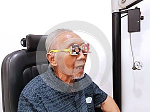 Old man checking his eyes at ophthalmologist