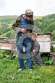 Old man and child, Georgia. Caucasus mountains. Summer season.
