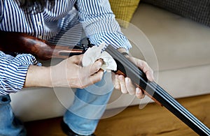 Old man cleaning a gun