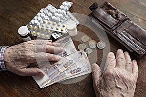 The old man is counting money to buy medicines.