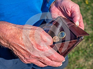 Old man counts his little money