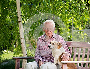 Old man with dog in garden