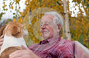 Old man with dog on bench in park