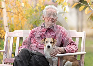 Old man with dog on bench in park