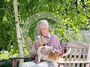 Old man with dog in garden