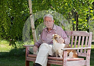 Old man with dog in garden