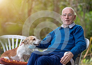 Old man with dog in garden