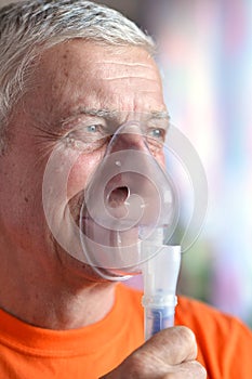 Old man doing inhalation