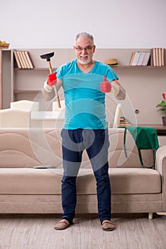 Old man doing plumbing at home