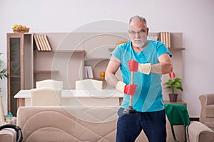 Old man doing plumbing at home