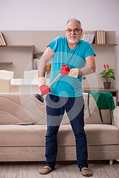 Old man doing plumbing at home