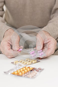 Old man dosing medicines photo