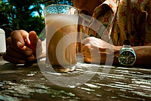 Old man with drinks and stopped time