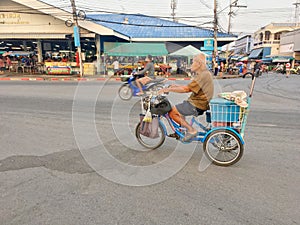 An old man driving his custome blue tricycle on the street of Paknampran, Hua Hin Thailand December 22, 2018