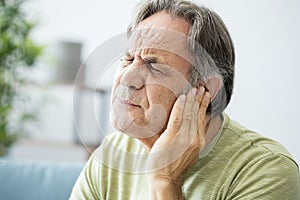 Old man with ear pain photo