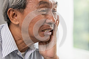 Old man elder toothache pain suffer from dental problem teeth caries decayed