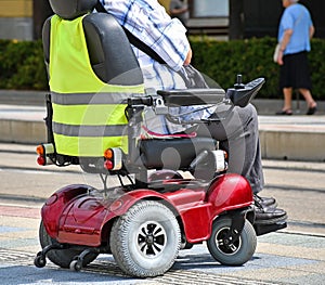 Old man with an electirc wheelchair on the street