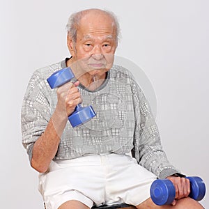 Old man exercise hold dumbbell
