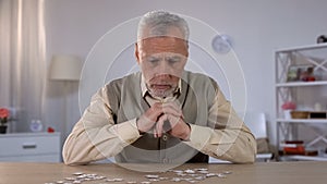 Old man exercises with puzzle, suffers cognitive impairment, Alzheimer symptom