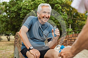 Old man exercising using hand gripper photo