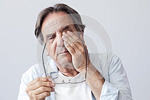 Old man with eye fatigue