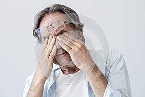 Old man with eye fatigue