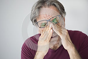 Old man with eye fatigue photo