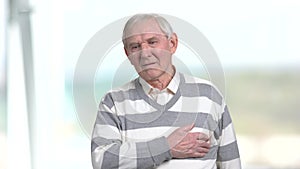 Old man feeling pain in his chest.