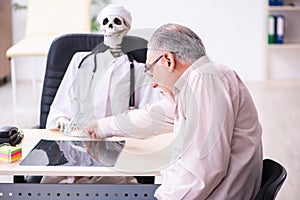 Old man giving money to dead doctor