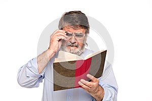 Old man with glasses reading a book