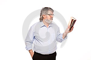 Old man with glasses reading a book