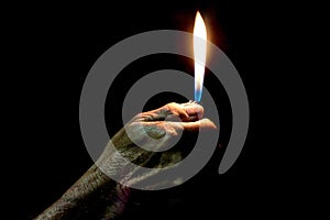 Old Man hand holding burning lighter